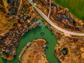 Aerial view of winding river and road in golden colored fall forest Royalty Free Stock Photo