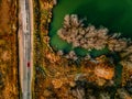 Aerial view of winding river and road in golden colored fall forest Royalty Free Stock Photo