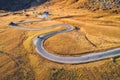 Aerial view of the winding road in autumn forest at sunset Royalty Free Stock Photo