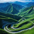 An aerial view of a winding road cutting through mountains or a coastal depicting