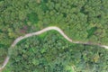 Aerial view of winding road with pine tree forest in mountain.Scenery Bird eye view of asphalt road landscape.High view from drone Royalty Free Stock Photo