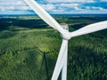 Aerial view of windmill close-up in green summer forest in Finland. Wind turbines for electric power and Renewable Energy