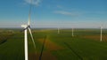 Aerial view of windmill farm producing power. Windmills creating natural energy. Royalty Free Stock Photo