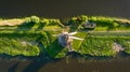 An aerial view of the windmill. Kinderdijk national park. Canals with water for agriculture. Fields and meadows.