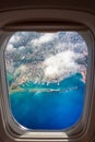 Aerial view through the window of an airplane of the beautiful city of Chania with it`s old harbor and the famous lighthouse.