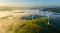 Aerial view of windturbine renewable energy farm winthwindmills on a foggy morning