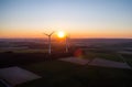 Aerial view of windturbines energy generator on amazing sunset at a wind farm in germany