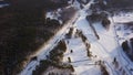 Aerial view of winter pine forest and snow path on a sunny day. Action. Flying over the panoramic view of the snow Royalty Free Stock Photo