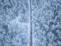 Aerial view of winter road and cars passing by  forest in mountains. drone shot Royalty Free Stock Photo