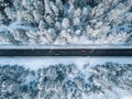 Aerial view of winter road and forest with snow covered trees in Finland Royalty Free Stock Photo