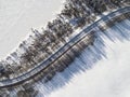 Aerial view of a winter road between two frozen lake. Winter landscape countryside. Aerial photography of snowy forest and frozen Royalty Free Stock Photo