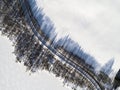 Aerial view of a winter road between two frozen lake. Winter landscape countryside. Aerial photography of snowy forest and frozen Royalty Free Stock Photo