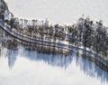 Aerial view of a winter road between two frozen lake. Winter landscape countryside. Aerial photography of snowy forest and frozen Royalty Free Stock Photo