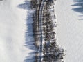 Aerial view of a winter road between two frozen lake. Winter landscape countryside. Aerial photography of snowy forest and frozen Royalty Free Stock Photo