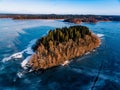 Aerial view of the winter snow forest and frozen lake from above captured with a drone in Finland. Royalty Free Stock Photo