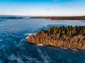 Aerial view of the winter snow forest and frozen lake from above captured with a drone in Finland. Royalty Free Stock Photo