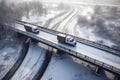 Aerial View of Winter Transportation: Trucks Traversing a Bridge in a Snowy Landscape, ai generative