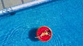 Young woman relaxing on watermelon in hotel resort pool. Top view of rich girl floating with fruit mattress drinking cocktail. Royalty Free Stock Photo