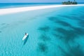 Aerial view of a woman paddleboarding on a beautiful tropical beach, Aerial view of a woman on a surfboard in the turquoise waters