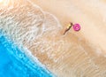 Aerial view of the woman with pink swim ring, sandy beach, sea Royalty Free Stock Photo