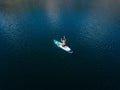 Aerial view on woman on sup board with paddle in the lake Royalty Free Stock Photo