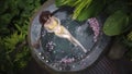 Aerial view of Woman in yellow bikini relaxing in hot tub in tropical. Royalty Free Stock Photo