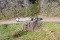 Aerial view of wood chipper blowing shredded wood into back of a truck. Forest background