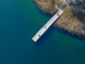 Aerial view of wood pier with fishers and their fishing rods trying to catch fish