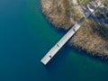 Aerial view of wood pier with fishers and their fishing rods trying to catch fish