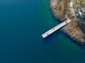 Aerial view of wood pier with fishers and their fishing rods trying to catch fish