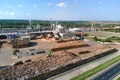 Aerial view of wood processing factory with stacks of lumber at plant manufacturing yard