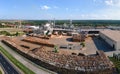 Aerial view of wood processing factory with stacks of lumber at plant manufacturing yard