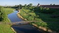 Aerial view of a wooden bridge over a small river, late spring in Suzdal. Royalty Free Stock Photo