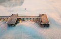 Aerial view of wooden dock on sandy beach Royalty Free Stock Photo