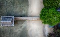 Aerial view of wooden dock on sandy beach by deserted water Royalty Free Stock Photo