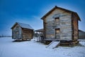 Aerial view of wooden farm sheds in snow covered field