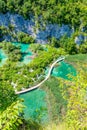 Aerial view of wooden footpath trail at Plitvice lakes, Croatia. Tourist path above blue lagoon near the waterfalls. Empty bridge Royalty Free Stock Photo