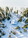 Aerial view of wooden log cabin in snow  winter forest by the lake in rural Finland Royalty Free Stock Photo