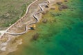 Aerial view of wooden path over turquiose lake colour. Drought. Drone top view Royalty Free Stock Photo