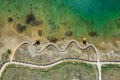 Aerial view of wooden path over turquiose lake colour. Drought. Drone top view Royalty Free Stock Photo