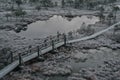 Aerial view of wooden path, road in swamp on early winter morning