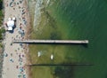 Aerial view on wooden pier on sea with sand beach and breakwaters Royalty Free Stock Photo