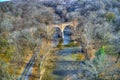 Aerial View of Woods in Fall Colors with a Road, Stream and Railroad Bridge