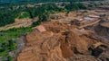 Aerial view of Work of trucks and the excavator in an open pit on gold mining. Central Sulawesi, Indonesia, March 3, 2022