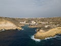 Xlendi bay with cliff and historic tower in front of the Xlendi town aerial Gozo Malta Royalty Free Stock Photo