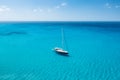 An aerial view of the yacht on the azure sea. Transparent clear water in the Mediterranean Sea. Summer vacations and travels on a Royalty Free Stock Photo