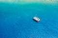 An aerial view of the yacht on the azure sea. Transparent clear water in the Mediterranean Sea. Summer vacations and travels on a Royalty Free Stock Photo