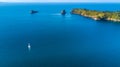 Aerial view on a yacht racing along tiny island ocean on sunny day. Coromandel Peninsula, New Zealand Royalty Free Stock Photo