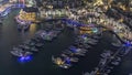 Aerial view on yachts floating in Dubai marina night timelapse. White boats are in canal water. Royalty Free Stock Photo