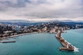 Aerial view of Yalta embankment from drone, old Lighthouse on pier, sea coast landscape and city buildings on mountains, Crimea Royalty Free Stock Photo
